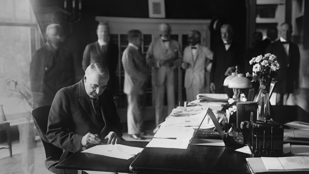President Warren Harding signing a bill into law, in the White House Oval Office. August 18, 1922.